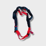 Detail shot of the Halti dog harness showing the brand logo and adjustment buckles
