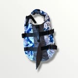 Close-up of the blue camo dog life jacket showing the adjustable buckles and Velcro straps.