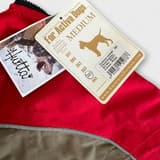 Hurtta dog overall in red and black, comfortable and durable for active dogs.