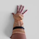 Long wrist pocket on an arm, with a zipper, in light orange with a yellow pattern.