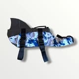 The blue camo dog life jacket laid flat, highlighting the detailed pattern and bright colors.