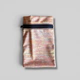 Yellow wrist treat pouch for dogs with pattern and zipper, shown against a blue background.