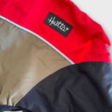 Red and black Hurtta dog overall in good condition, perfect for active dogs.