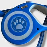 Overview of the Zoofari retractable leash with carabiner and its extended nylon line, showing its 5-meter length.